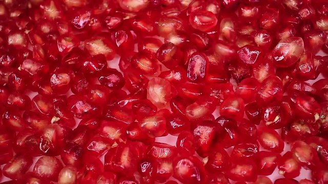 Pomegranate seeds food closeup texture pattern seamless looping rotating video footage hd resolution.