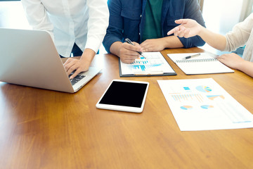 Group of teamwork businessman and woman in the meeting work to analysis marketing data concept business discussion.,with white computer screen with clipping path