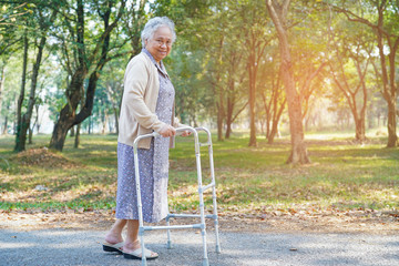 Asian senior or elderly old lady woman patient walk with walker in park : healthy strong medical...
