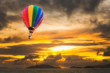 Fototapeta na wymiar Hot air balloons over the ocean at sunset with dramatic sky. Honolulu Hawaii