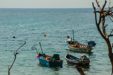 Obraz premium Beautiful view of fisherman boats moored on the beach of fisherman village at Naiyang beach, Phuket, Thailand.