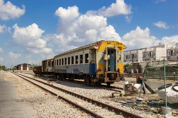 Fototapeta premium The old train carriages were not in use, parked on the tracks inside the abandoned train station.
