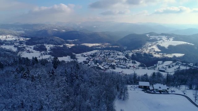 4k aerial winter shot of a small European town with church