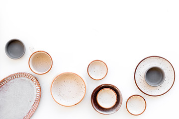 Ceramic tableware pattern. Empty plates and mugs on white background top view space for text