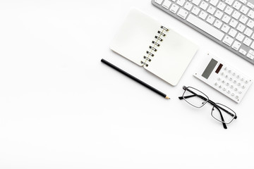 Office desk in order. Geometry. Computer keyboard and office supplies, glasses on white background top view copy space