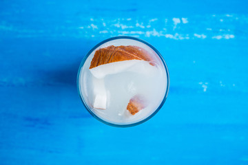 Sweet coconut cocktail on the wooden background. Selective focus. Shallow depth of field.