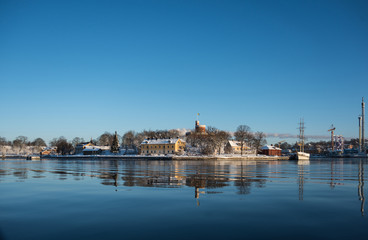 A cold winter  day in Stockholm with snow and ice on islands and boats