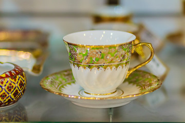 Vintage Thai's style porcelain coffee cup handmade. Beautiful traditional Thai five-colored porcelain ceramic coffee cup. Benjarong Porcelain coffee cup for sale in the flea market, Thailand.