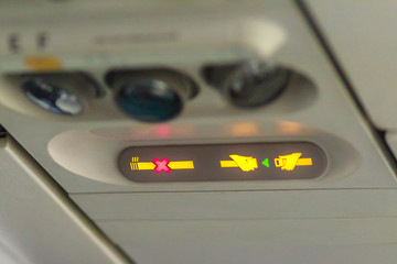 No Smoking and Fasten Seat belt Sign Inside an Airplane. Fasten seat belt and no smoking sign in aircraft