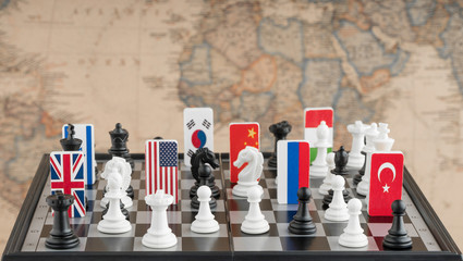 Country flag symbols on the chessboard with figures on the background of the political map of the...