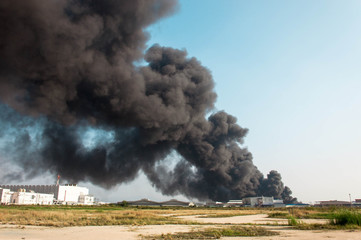 Fototapeta na wymiar One of factory is burning with big black smoke in sky 
