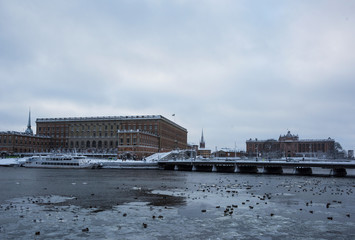 Government buildings and castle a gray snowy winter day in stockholm