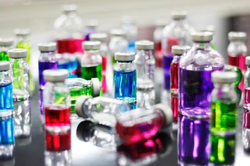 Many of colorful liquid medicine vial glass for experiment in Pharmaceutical Laboratory.
