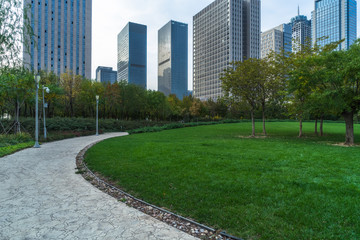 park pedestrian walkway and modern skyscrapers, dalian city, china.