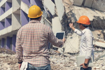 Engineer architect and worker operation control demolish old building.