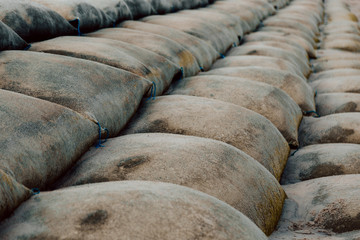 Rows of Sand big bag on the beach..Sand bags are protecting coastal erosion by Waves from the sea.