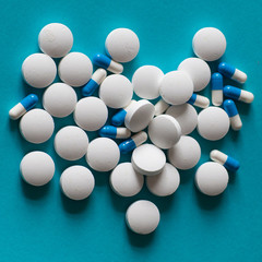 Medicine. Course of treatment. Scattered pills on a blue background