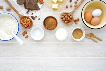 Obraz na płótnie Canvas Ingredients for making chocolate baking on white wooden background