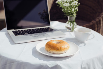 Laptop, bread and cafe in coffee shop