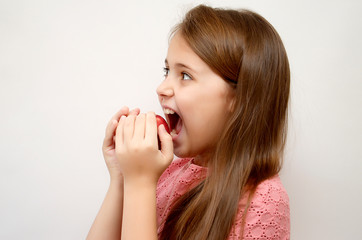  girl on a light background with a red Apple in her hands