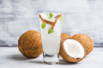 Sweet coconut mojito cocktail on the wooden background. Selective focus. Shallow depth of field.