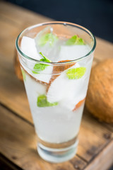 Sweet coconut mojito cocktail on the wooden background. Selective focus. Shallow depth of field.