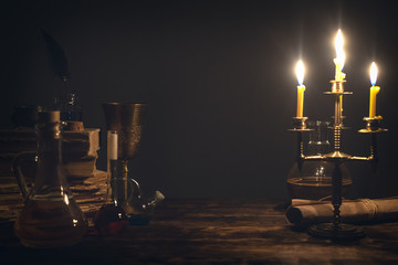 Alchemist table with a gold ore above. Alchemistry science concept. - obrazy, fototapety, plakaty