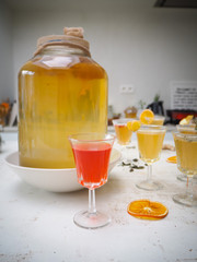 Multiple glasses with a variety of flavored kombucha tea such as cinnamon, citrus, turmeric and rosemary