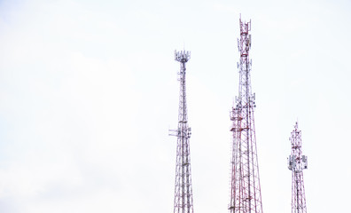 Obraz premium Radio masts and towers, tall manmade guyed or self supported tubular tube metal frame structures building designed to support antennas for telecommunications and broadcasting. Technology and Industry.