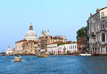 people on boats in venice. sea ​​in italy. clear summer weather in venice. view of the cathedral and the house. home on stilts. boats float on the water and carry tourists. a sky without clouds and a 