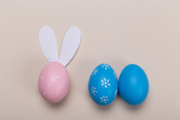 Colorfull easter eggs in nest on pastel color background with space. Concept