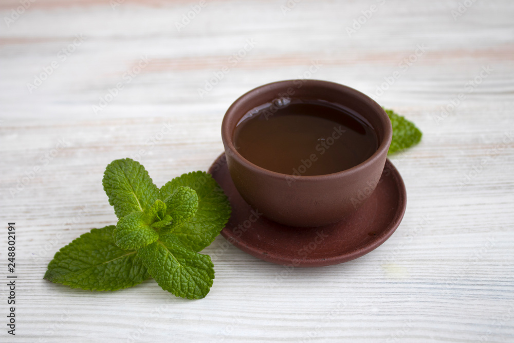 Wall mural mint tea on a white wood background