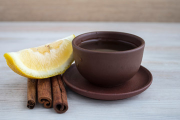 lemon and cinnamone tea on a white wood background