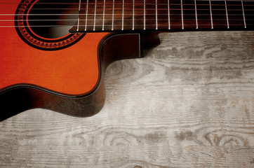 Acoustic guitar on a wooden texture