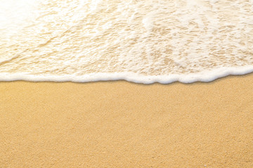 Soft waves with foam sea on golden sand with copy space. Summer beach vacations sunset time background. Phuket Thailand.