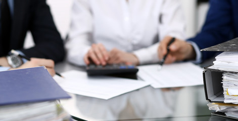 Binders with papers are waiting to be processed with bookkeeper. Internal Revenue Service inspector working place. View from above