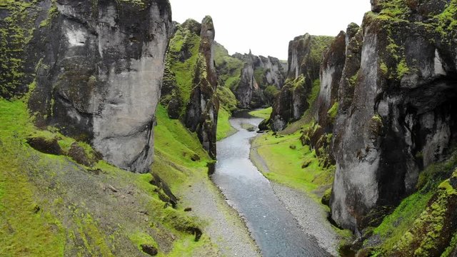 Flying through the Fja√∞r√°rglj√∫fur Canyon (AKA Justin Bieber Canyon) in Iceland with towering rock walls and the Fja√∞r√° river winding below