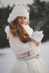 little happy beautiful girl in winter forest