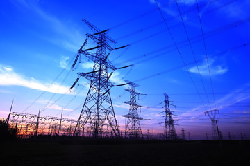 In the evening, the silhouette of high voltage towers