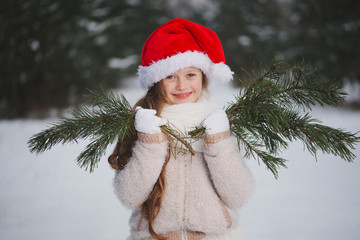 little happy beautiful girl in winter forest