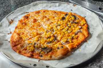 Homemade pizza with cheddar cheese and corn