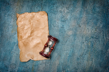 Mock up of empty old vintage yellowed paper sheet with sandglass