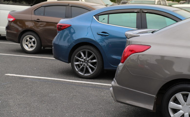 Closeup of back or rear side of brown car and other cars parking in parking area.