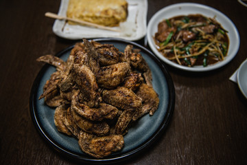 Fried chicken wing and Fried chicken drumstick with black pepper in Japanese style served with Omelette and stir fried pork liver with Chinese chives.