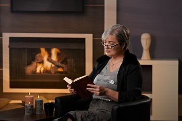 Mature woman at fireplace