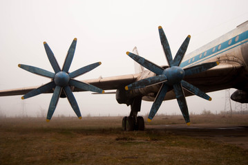  propellers of an old passenger plane in a hazy haze with blue frayed blades
