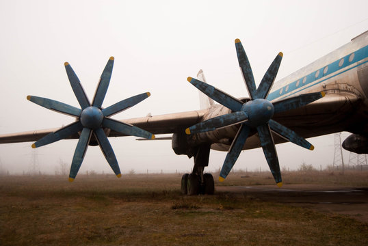  Propellers Of An Old Passenger Plane In A Hazy Haze With Blue Frayed Blades