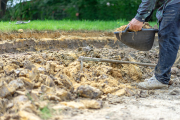 gardener digs the soil with his equipment for gardening and prepare land for plantation.