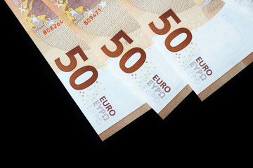 Fifty euro banknotes on a dark background close up