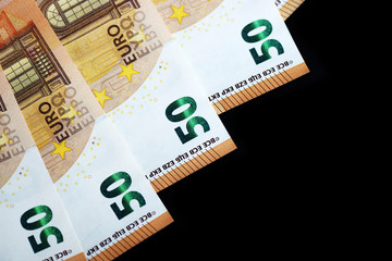Fifty euro banknotes on a dark background close up